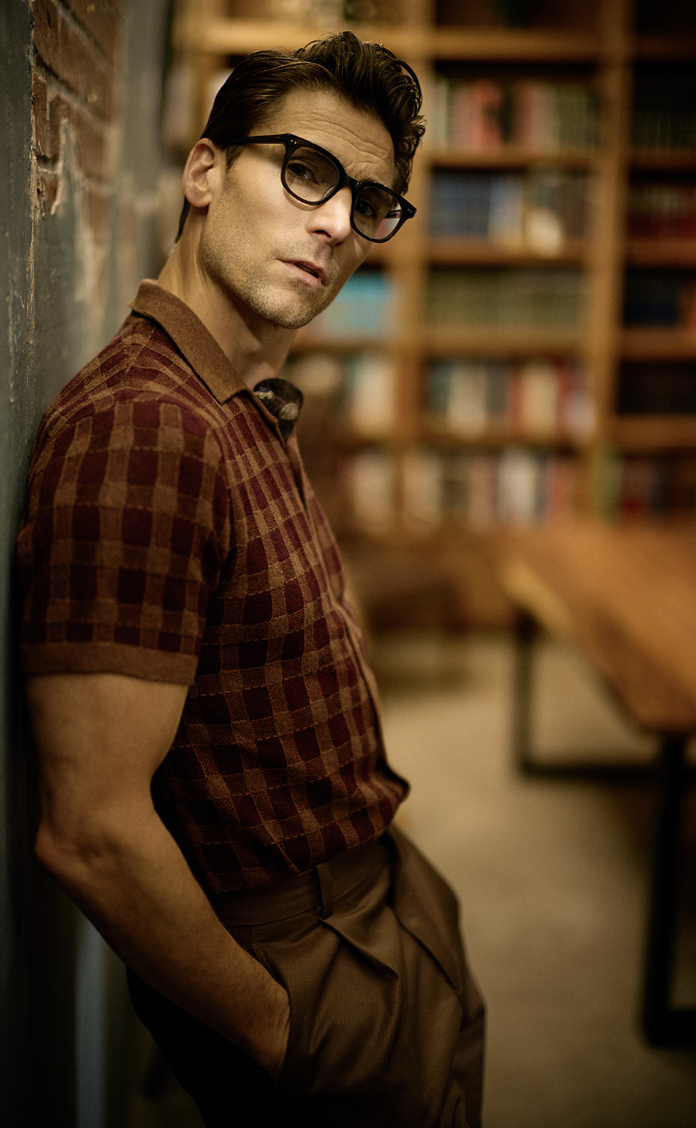 Andrew Walker wearing glasses in a library
