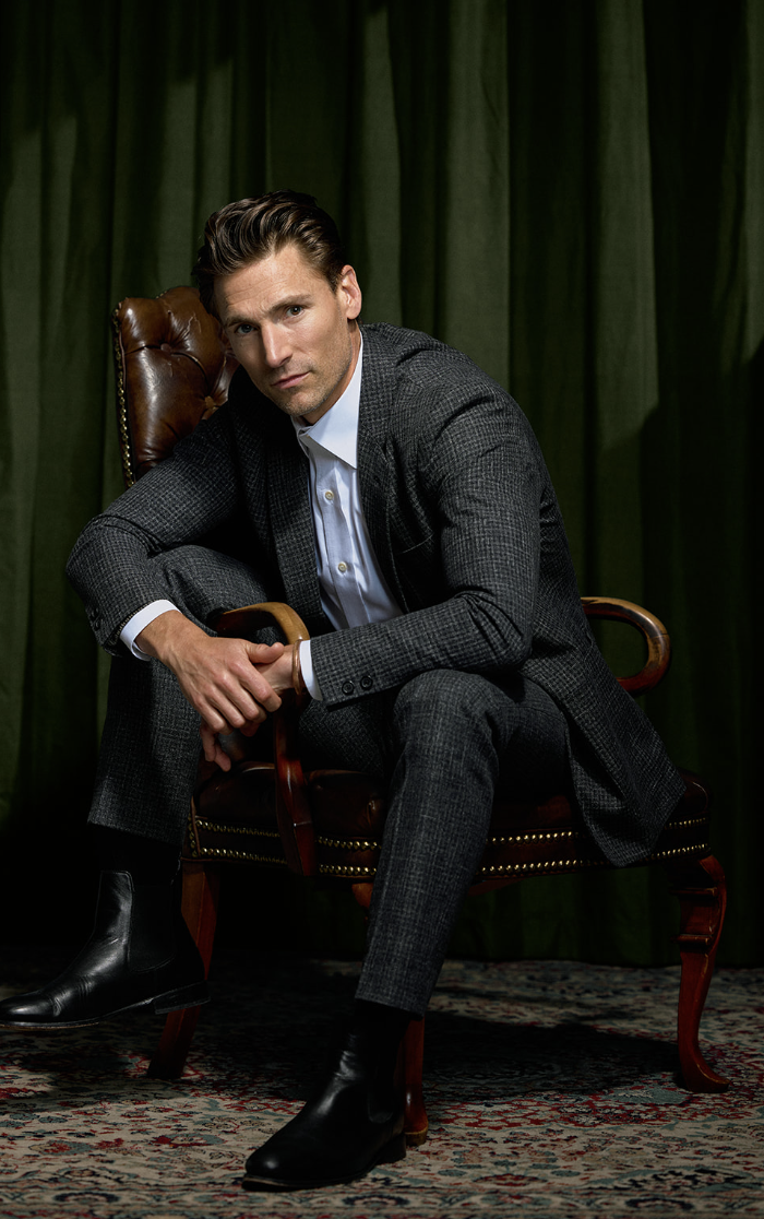 Andrew Walker seated in a brown leather chair
