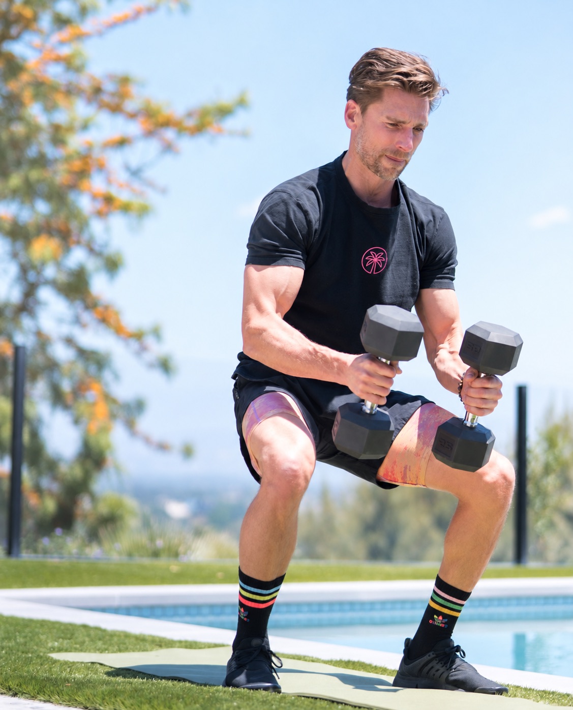 Andrew Walker exercising with dumbbells outdoors